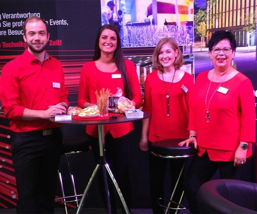 Bild von Mitarbeitern der Stadthalle Reutlingen in roten Hemden und Blusen